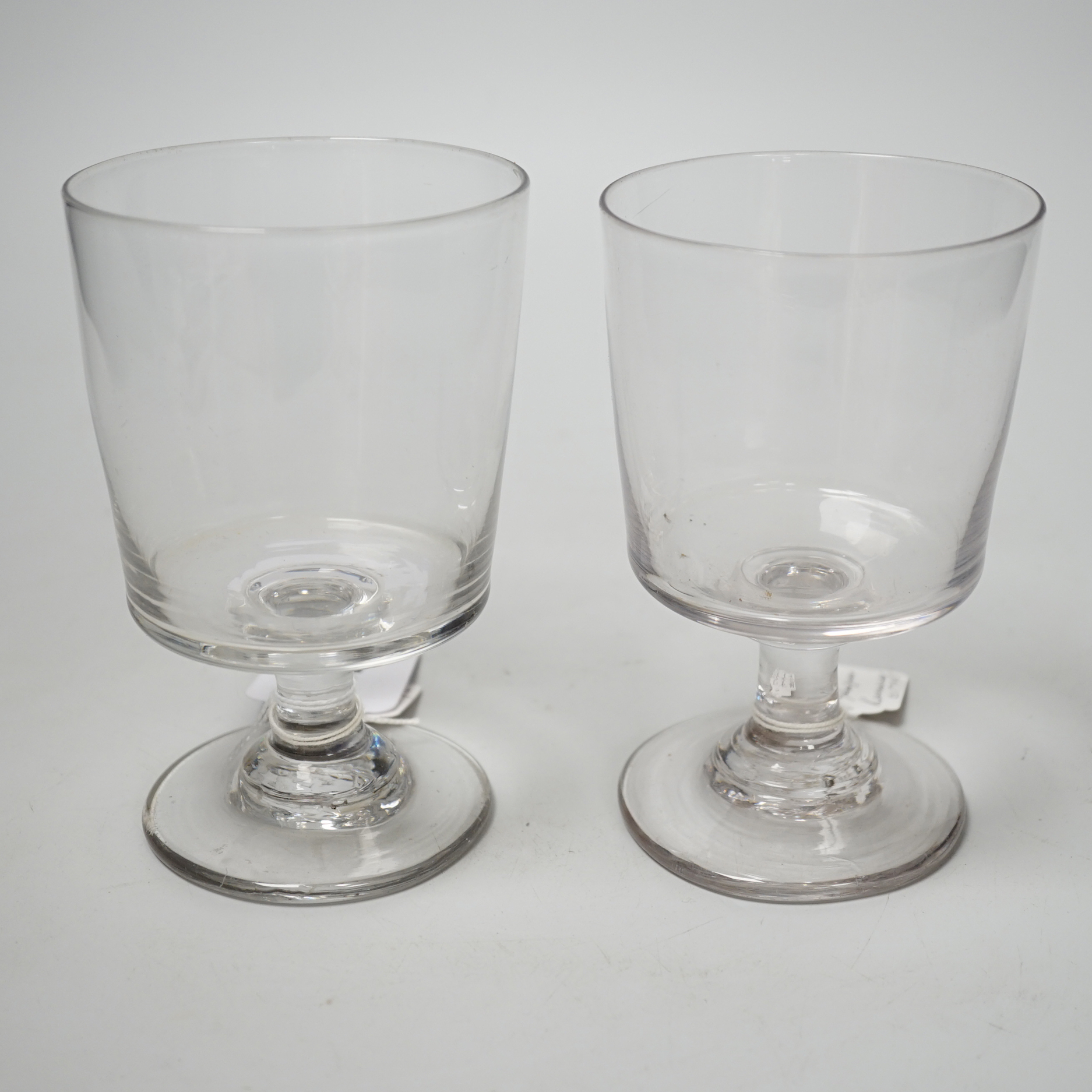 Two early 19th century English lead crystal rummers, in the form of square bucket shapes, with capstan stems and plain foot. 14.5cm highest